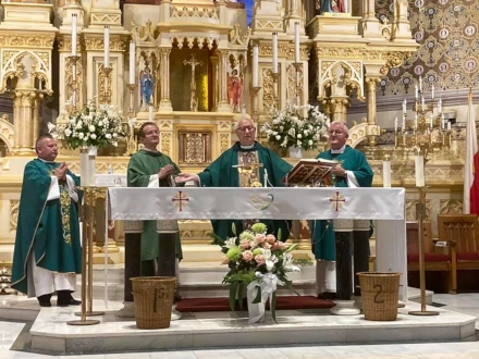 Priests celebrating Mass at an ornate altar inside a church