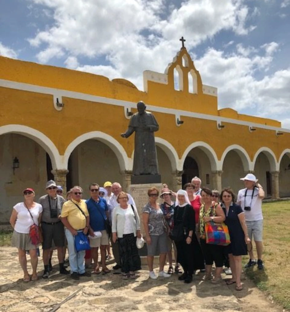 Group of pilgrims visiting a religious site during a spiritual journey